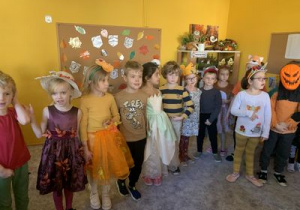 Dzieci słuchają nauczycielki rozpoczynającej bal jesieni