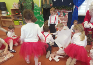 Dzieci wspólnie otwierają świąteczne prezenty
