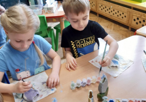 Dzieci malują ceramiczne kwiatki