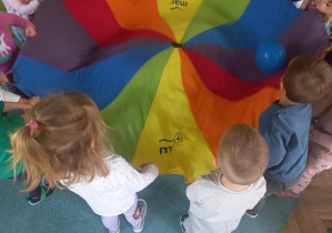 Dzieci podrzucają balon chustą animacyjną