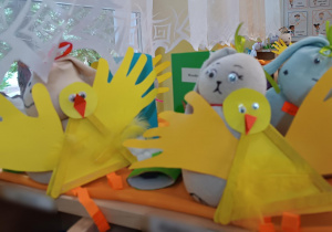 Kurczaczki wykonane przez dzieci z żółtego brystolu i żółtych piórek.