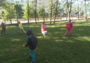 Dzieci biegają i spacerują po ogrodzie